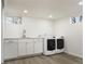 Basement laundry room with white cabinets, washer, and dryer at 1025 Collyer St, Longmont, CO 80501