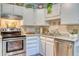 Kitchen features white cabinets, granite counters, and stainless steel appliances at 13609 E Cornell Ave # 107, Aurora, CO 80014