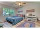 Bedroom with a queen-size bed, large window, and wood-look floors at 13609 E Cornell Ave # 107, Aurora, CO 80014