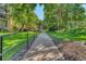 Landscaped walkway with bordering grass and trees at 13609 E Cornell Ave # 107, Aurora, CO 80014