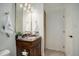 Bathroom with granite countertop and dark wood vanity at 8457 Thunder Ridge Way # 103, Highlands Ranch, CO 80126