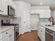 Kitchen with white shaker cabinets, stainless steel appliances, and an island at 3443 N Irvington St, Aurora, CO 80019