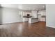 Kitchen and living area with white cabinets, an island, and wood-style flooring at 3443 N Irvington St, Aurora, CO 80019