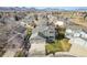 Aerial view of two-story house with landscaped yard and mountain views at 5327 S Pierson Ct, Littleton, CO 80127