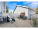 Backyard with detached garage, concrete patio, and white fence at 5775 Biscay St, Denver, CO 80249