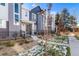 Modern townhomes with gray and white exteriors, landscaping, and a walkway at 1983 S Poplar Ct, Denver, CO 80224