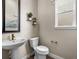 Small bathroom with pedestal sink, toilet and hexagon tile floor at 5936 N Lisbon St, Aurora, CO 80019