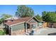 Quaint green house with stone accents and a large yard at 624 Stuart St, Denver, CO 80204