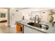 Open concept kitchen with granite island and stainless steel sink at 624 Stuart St, Denver, CO 80204