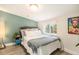 Spacious bedroom with a teal accent wall and window seat at 624 Stuart St, Denver, CO 80204