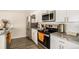 Bright kitchen, featuring stainless steel appliances and white cabinets at 624 Stuart St, Denver, CO 80204