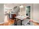 Modern dining area with table, bench seating, and open kitchen view at 2438 Welton St, Denver, CO 80205