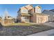 Two-story house with beige siding, attached garage, and a small porch at 388 Evans Blvd, Elizabeth, CO 80107