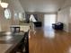 Dining area with hardwood floors and a view of the living room at 1266 S Ammons St, Lakewood, CO 80232