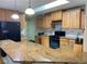 Spacious kitchen with granite countertops and black appliances at 1266 S Ammons St, Lakewood, CO 80232