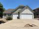 Two-story house with a two-car garage and landscaped front yard at 1266 S Ammons St, Lakewood, CO 80232