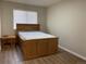 Bedroom with wood-look floors and a wooden bed frame at 1266 S Ammons St, Lakewood, CO 80232