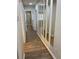 Long hallway with wood-look floors and mirrors at 1266 S Ammons St, Lakewood, CO 80232