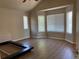 Spacious primary bedroom with large windows and wood-look floors at 1266 S Ammons St, Lakewood, CO 80232