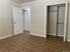 Bedroom with wood-look floors and access to another room at 1266 S Ammons St, Lakewood, CO 80232