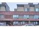 Modern brick townhome exterior with large windows and covered porch at 3933 Inca St, Denver, CO 80211