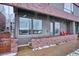 Covered front porch with metal railings and brick flooring at 3933 Inca St, Denver, CO 80211