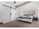 Main bedroom with king bed, barn door, and ceiling fan at 931 S York St, Denver, CO 80209