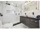 Elegant bathroom featuring a walk-in shower, double vanity, and modern fixtures at 3661 Miller St, Wheat Ridge, CO 80033