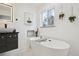 Relaxing bathroom with freestanding soaking tub, double sinks and window at 3661 Miller St, Wheat Ridge, CO 80033