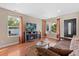 Bright living room with hardwood floors, fireplace, and comfortable seating at 5555 Perth Ct, Denver, CO 80249