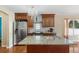 Island kitchen with granite countertops and stainless steel appliances at 5555 Perth Ct, Denver, CO 80249