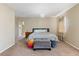 Spacious primary bedroom with plush carpet and large window at 5555 Perth Ct, Denver, CO 80249