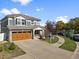 Two-story house with gray siding, brown garage door, and landscaped yard at 5555 Perth Ct, Denver, CO 80249