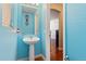 Light blue powder room with pedestal sink at 5555 Perth Ct, Denver, CO 80249