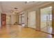 Living area with hardwood floors, sliding glass doors, and a view into another room at 3333 Colorado Blvd, Denver, CO 80205