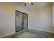 Carpeted bedroom with mirrored sliding doors at 3333 Colorado Blvd, Denver, CO 80205