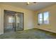 Bright bedroom featuring a sliding glass door and carpet flooring at 3333 Colorado Blvd, Denver, CO 80205