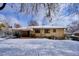 Back exterior of house showing patio and snowy yard at 2765 S Winona Ct, Denver, CO 80236