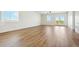 Spacious living room with light hardwood floors and access to a deck at 42962 Colonial Trl, Elizabeth, CO 80107