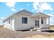 White exterior home with covered back porch and landscaping at 42962 Colonial Trl, Elizabeth, CO 80107