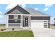 Modern craftsman style home with gray and white exterior, stone accents, and a two-car garage at 42962 Colonial Trl, Elizabeth, CO 80107
