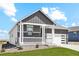 Two-story craftsman style home with gray and white exterior, stone accents, and a two-car garage at 42962 Colonial Trl, Elizabeth, CO 80107