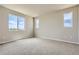 Bright bedroom with carpet flooring and two windows offering natural light at 5734 Ranch St, Mead, CO 80504