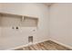 Laundry room with built-in shelving and vinyl flooring at 5734 Ranch St, Mead, CO 80504