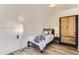 Small bedroom with wood wardrobe and adjacent door at 500 Jackson St, Denver, CO 80206