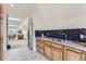 Well-appointed kitchenette with wood cabinets and patterned tile floor at 500 Jackson St, Denver, CO 80206