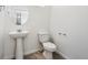 Clean and bright bathroom with pedestal sink and toilet at 9859 Biscay St, Commerce City, CO 80022