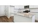 Modern kitchen island with granite countertop and stainless steel sink at 9859 Biscay St, Commerce City, CO 80022