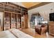 Main bedroom with wood shelving and access to patio at 5237 Bear Mountain Dr, Evergreen, CO 80439