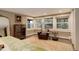 Bright bedroom with mountain views, sitting area, and hardwood floors at 5237 Bear Mountain Dr, Evergreen, CO 80439